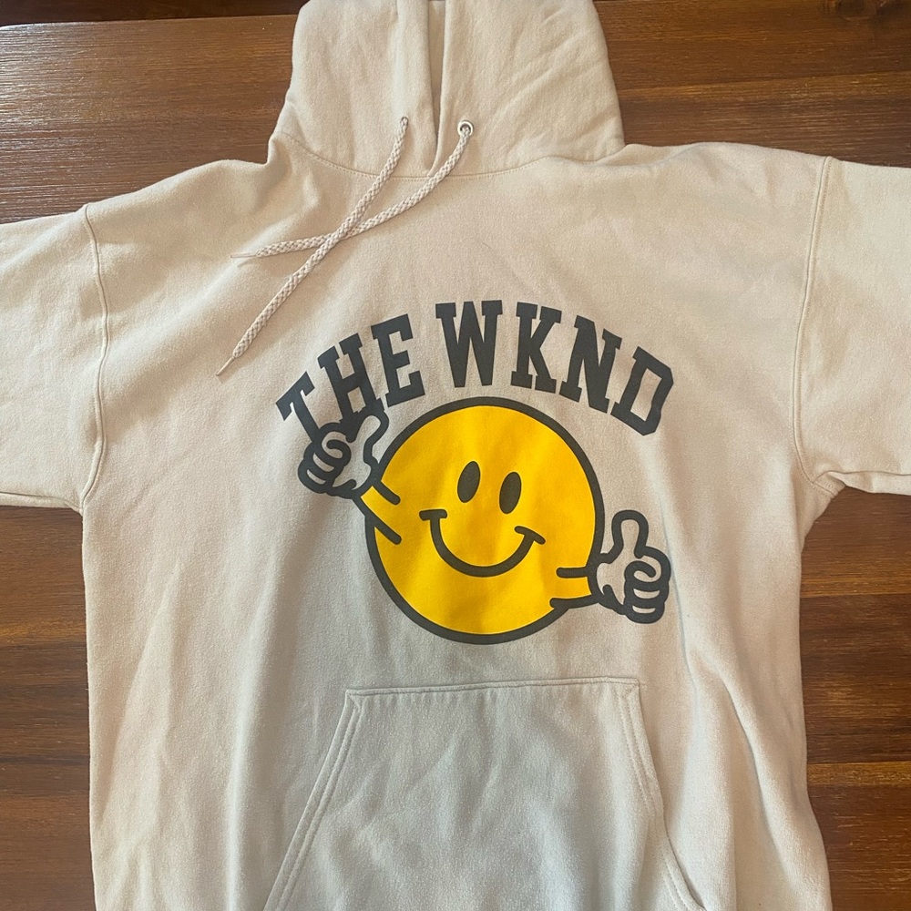 THE WKND Cream Hoodie with Yellow Smiley Graphic